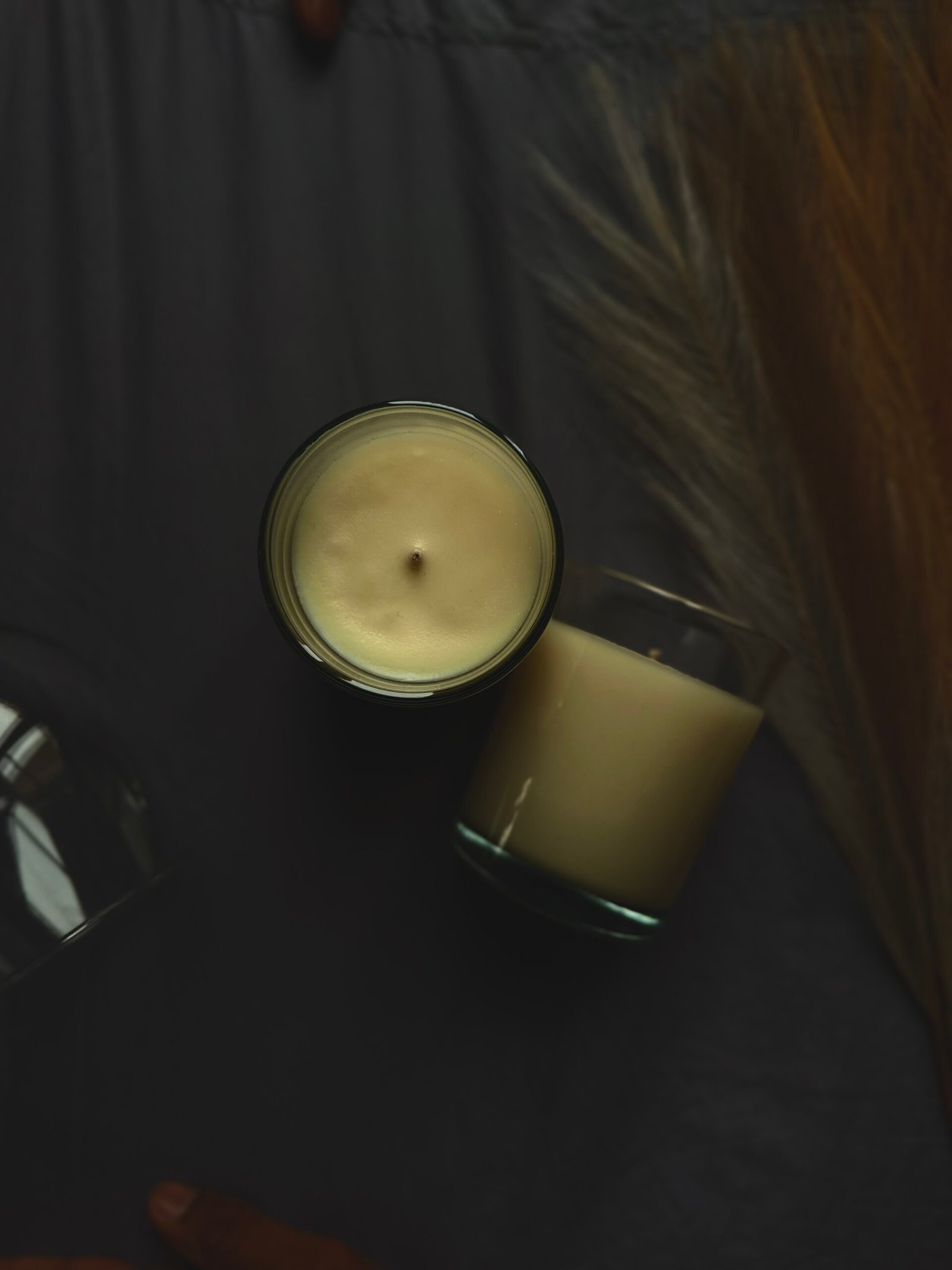 Deux bougies de luxe coulées à la main dans des contenants en verre minimalistes, parfumées avec des fragrances exclusives de Grasse. Un symbole de l'artisanat français, de l'élégance durable et de la beauté intemporelle. Two luxury hand-poured candles in minimalist glass vessels, infused with exclusive Grasse fragrances. A symbol of French craftsmanship, sustainable elegance, and timeless beauty. flamme delixir, flame delixir, Flamme delixir, Flame elixir, flamme elixir, elixir flame, elixir flamme, bougie de luxe, bougie luxe